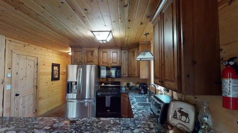 Full size kitchen with appliances, pots and pans, dishes, utensils, and cooking essentials.
