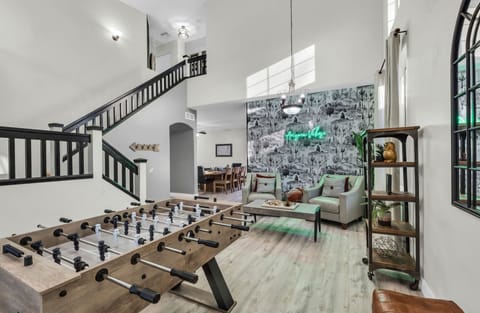 Gorgeous living room with cactus accent wall and foostable