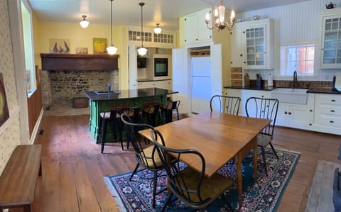 Spacious kitchen with two sinks, dishwasher, wall oven, cooktop, & refrigerator