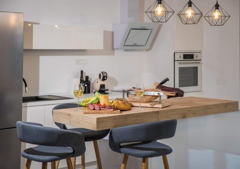 Kitchen island with traditional snacks, cheese and prosciutto in the kitchen of a luxury villa with concierge service and private pool near Dubrovnik