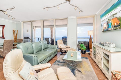 Sink into the plush sofa and let the ocean breeze drift through—your perfect retreat with stunning sea views awaits just beyond the balcony doors.