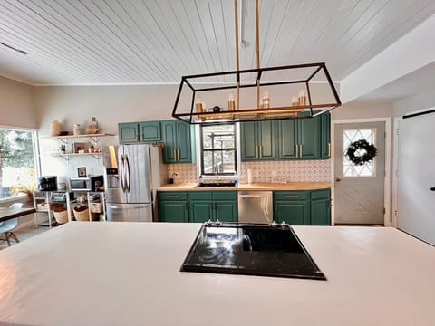 Beautifully renovated kitchen with large island and stainless steel appliances.