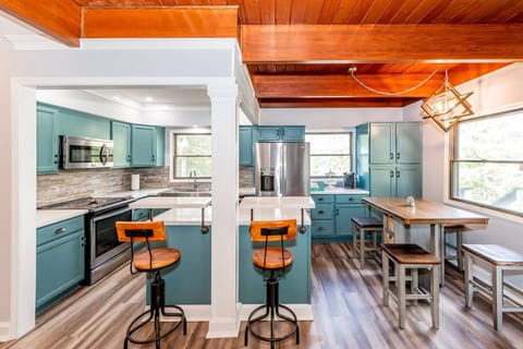 This open kitchen offers stainless steel appliances, a coffee bar, and comes stocked with all the essentials for cooking full meals