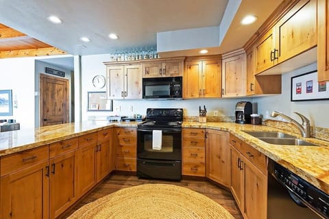 Fully-equipped kitchen with modern appliances and breakfast bar seating