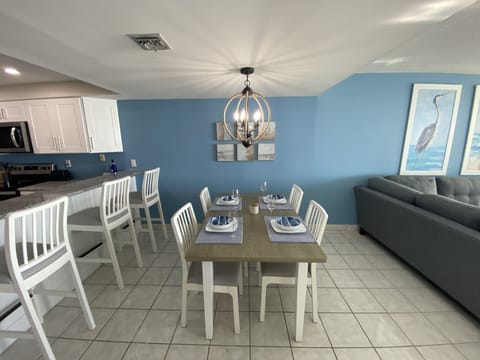 Table easily seats four can accommodate 6 and 3 more at the kitchen bar. 