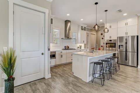 Luxury Fully Equipped Kitchen with Stainless Steel Appliances, Beautiful Quartz Countertops, Spacious Pantry, and Bar Stool Seating for 4