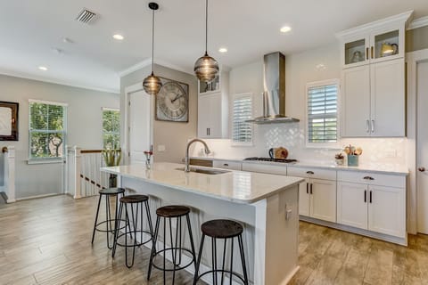 Luxury Fully Equipped Kitchen with Stainless Steel Appliances, Beautiful Quartz Countertops, Spacious Pantry, and Bar Stool Seating for 4