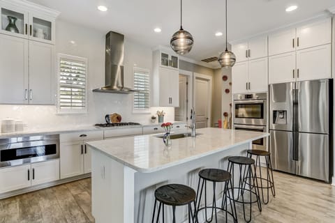 Luxury Fully Equipped Kitchen with Stainless Steel Appliances, Beautiful Quartz Countertops, Spacious Pantry, and Bar Stool Seating for 4