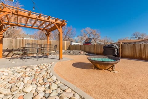 Relax under the pergola or unwind by the firepit.