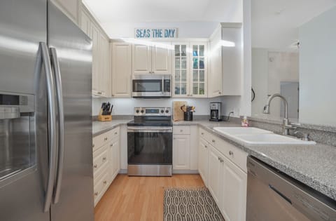 Fully stocked kitchen with plates, glassware and utensils. Dishwasher & microwav