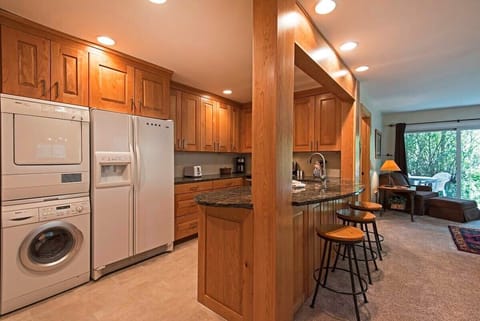 Fully-equipped kitchen with breakfast bar stool seating