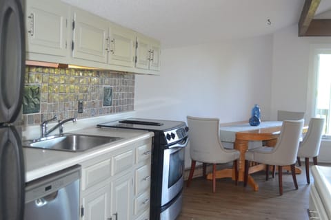 Kitchen and dining area are open concept, bright and open