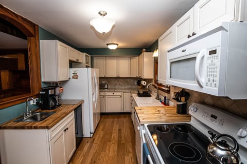Large kitchen with stocked w pots pans baking and knive set, ready for you!