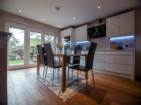 Downstairs dining area and kitchen with bi-fold doors to walled garden 