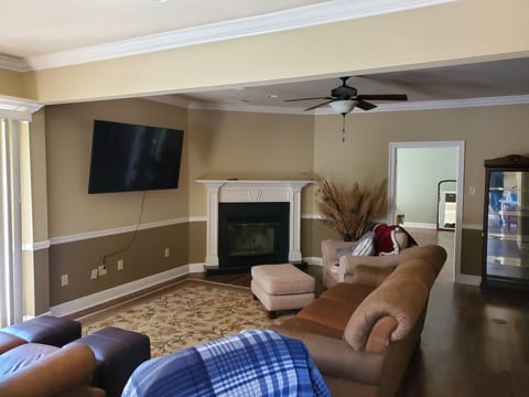 Living room w 65in wall mounted smart TV, base, chair rail, crown molding thr
