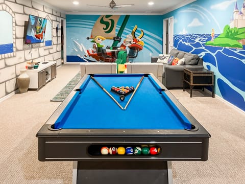 Legend of Zelda themed family room with pool table, TV, Xbox 360 video games.