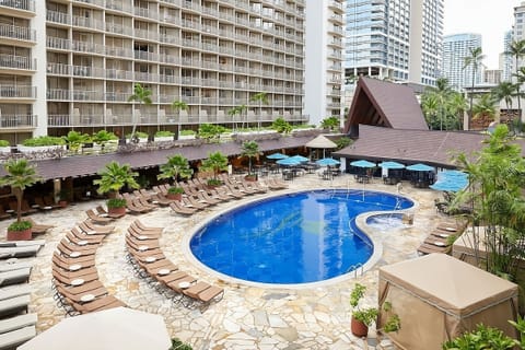 Dive into the resort-style pool surrounded by loungers.