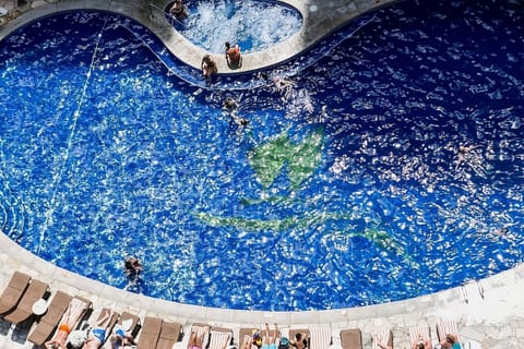 Sip tropical drinks and linger beside the sparkling pool.