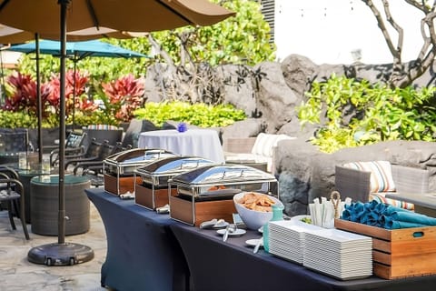 Gather for catered bites in a lush, shaded courtyard.