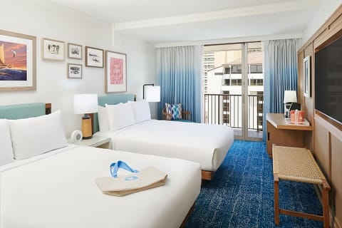 Unwind in a bright room with balcony breezes and plush beds.