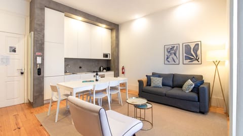 Relax in the inviting living area on a comfortable sofa after a day of exploring, or gather around the dining table for memorable meals prepared in the sleek, integrated kitchen. #OpenConceptLiving #ModernApartment #ComfortableSofa #DiningSpace #SleekKitc
