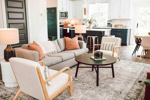 Space-saving comfort: this living room features a queen-sized pull-out sofa bed, offering a cozy retreat for guests without compromising on style or space.