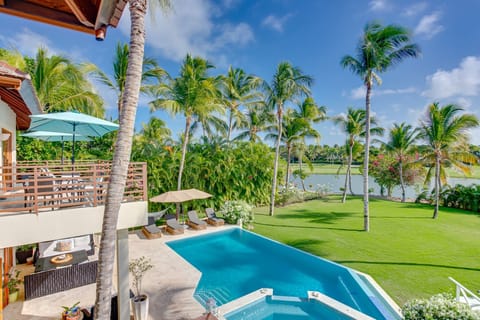 Pool area with hot tub, lake and golf views, outdoor living and a large garden