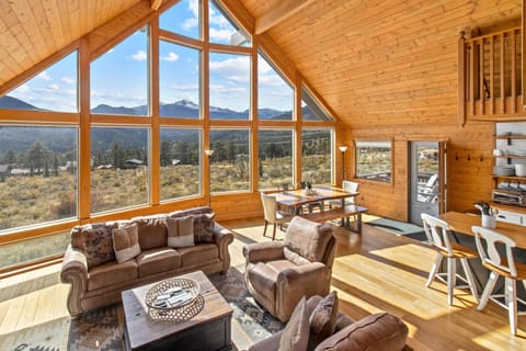 Sunlit living room with panoramic mountain views and cozy seating