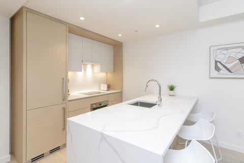 Kitchen with waterfall quartz counters