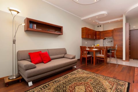 A cozy living room with a sofa, coffee table, TV, and warm lighting, decorated in a modern yet homely style.