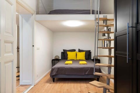 Bedroom with a double bed on the ground fllor and a 2nd level platform