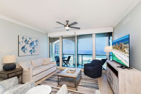 Step into your coastal retreat where soft blues and creamy whites create a serene escape. Sink into the plush sofa and let beach breezes drift in through your private balcony door, where endless gulf views await.