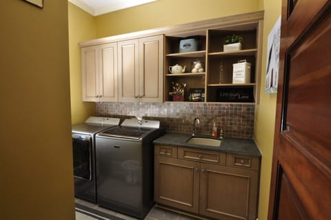 Laundry room with iron, ironing board, & detergent is available for any washing.