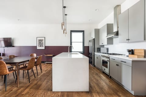 Modern kitchen features top appliances.