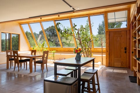 As an Earthship, the great room enjoys passive solar and indoor planters.
