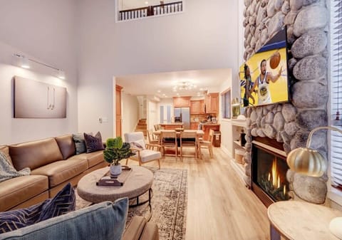 Living Room: Stylish retreat with a stunning stone fireplace and vibrant views.