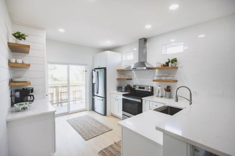 Chef's kitchen leading outdoors to the patio and pool.