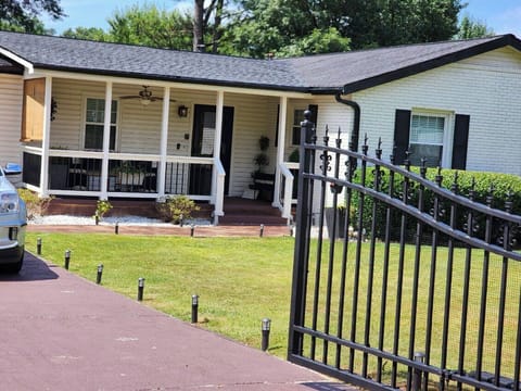 Gated Driveway and Front Porch w/chairs and ceiling fan