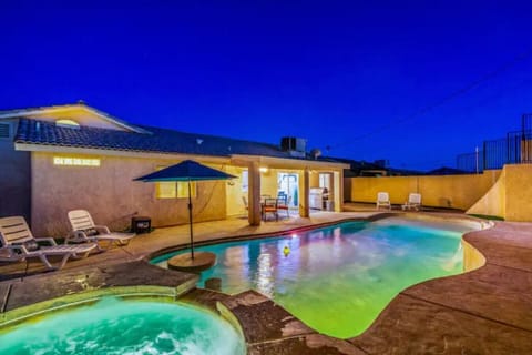 Nighttime photo - play pool oasis in full effect! Color changing pool lights, shallow end of pool, deep end of pool, hot tub, ultimate backyard!