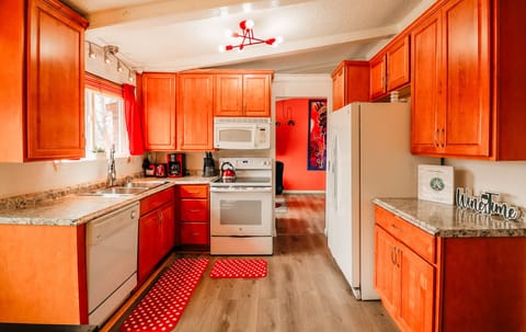 A sleek white stove and dishwasher set the tone for a kitchen that's both functional and stylish.