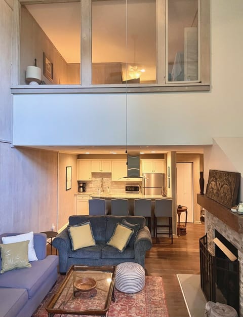 Primary bedroom looks down upon living area