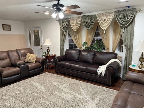 Comfortable family room with leather sofa bed and 55" smart TV
