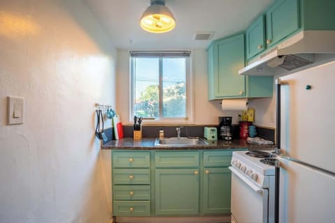 Compact kitchen — equipped with toaster, coffee machine, and cooking utensils. 