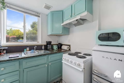A clean, functional kitchen with mint-green cabinets and all the basics you need for cooking.