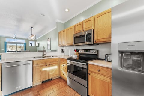 Full size kitchen with hardwood flooring and everything you need to prepare a meal away from home.
