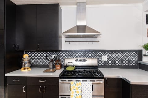 The kitchen is well stocked with useful appliances, pots, pans, utensils, flatware and table settings for 6