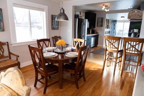 High end farmhouse furniture, dishes and flatware with extra seating in the dining room