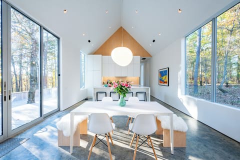 Dining Room: Sun-drenched space with nature views, perfect for gatherings and unforgettable meals!