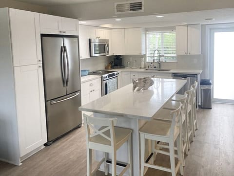 Kitchen with island dining with 6 high stools
