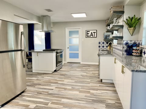 Kitchen: gas cooking, pantry, open shelving, plenty of storage & counter space